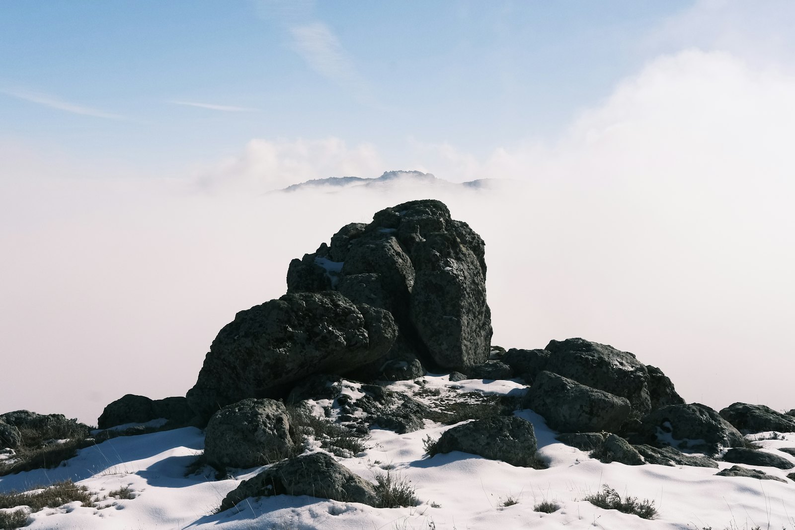 A mountain peak rising above the clouds