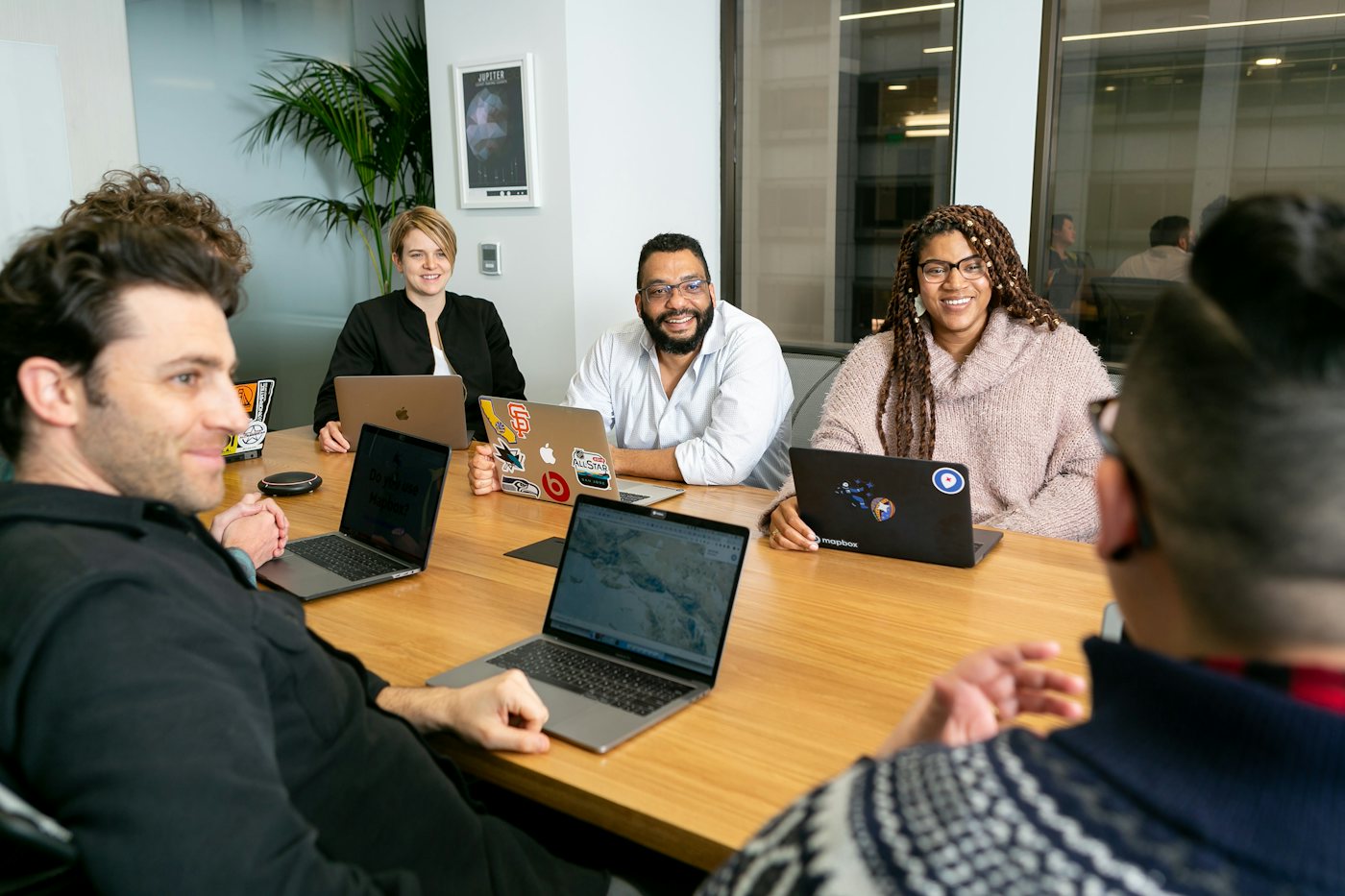 Four colleagues in a meeting around laptops