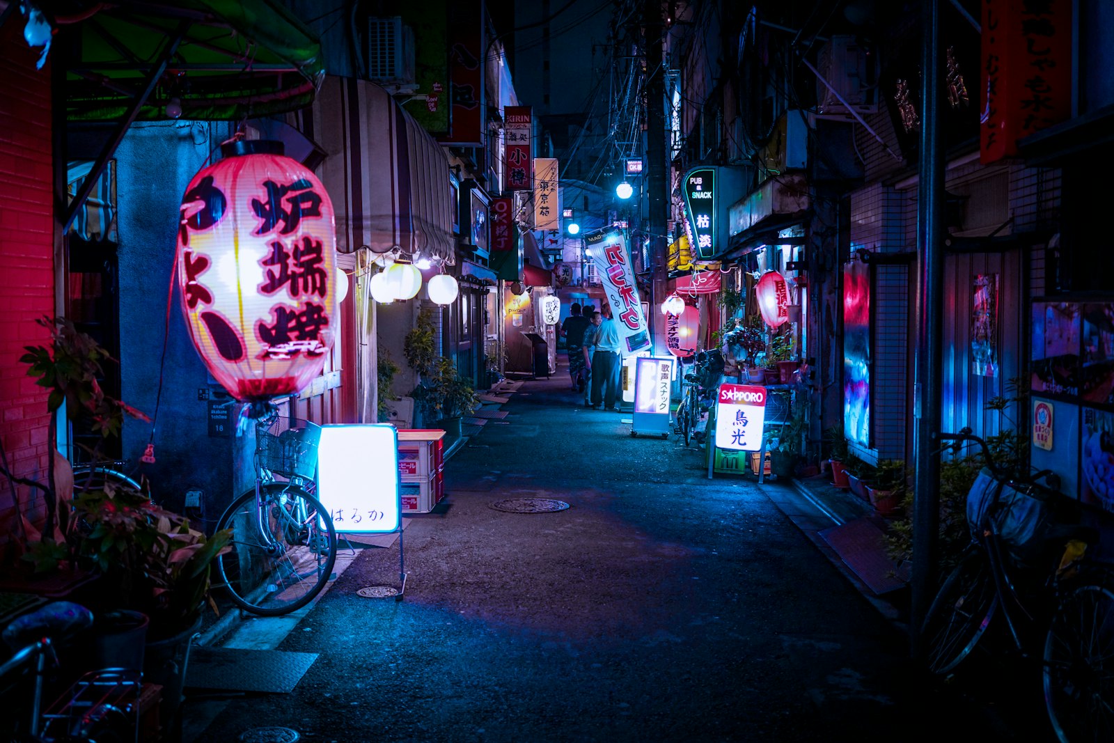 Neon signs on a busy city street at night