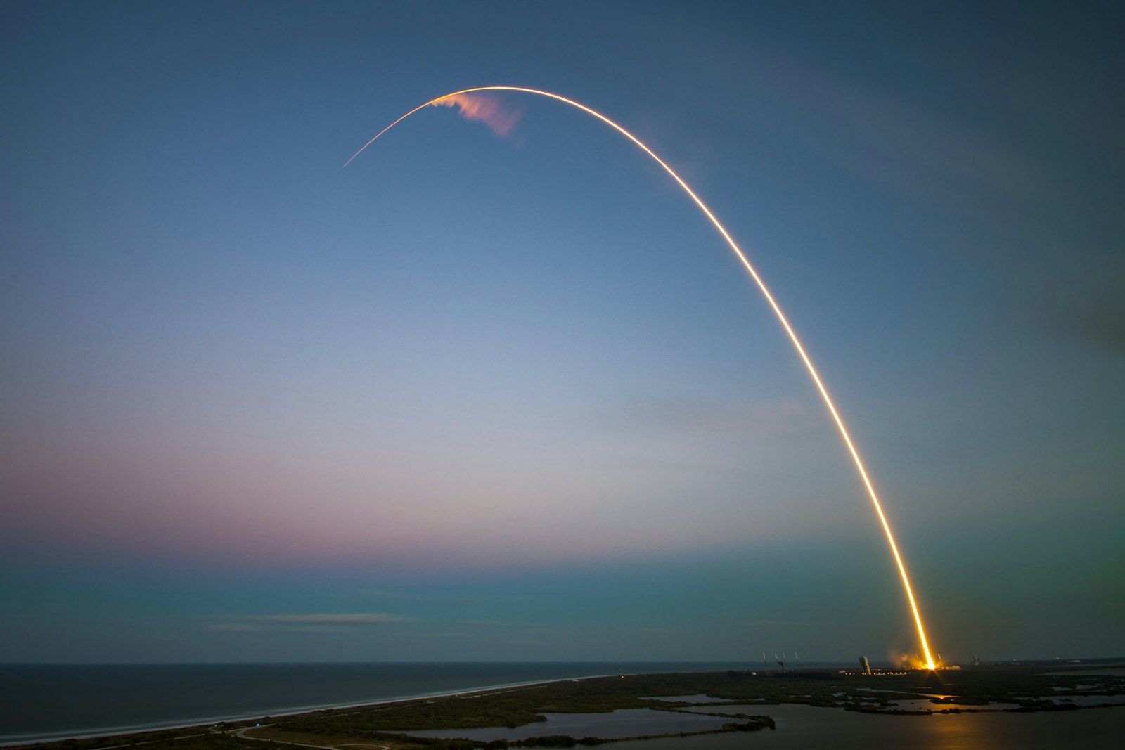 A rocket arcing into the evening sky