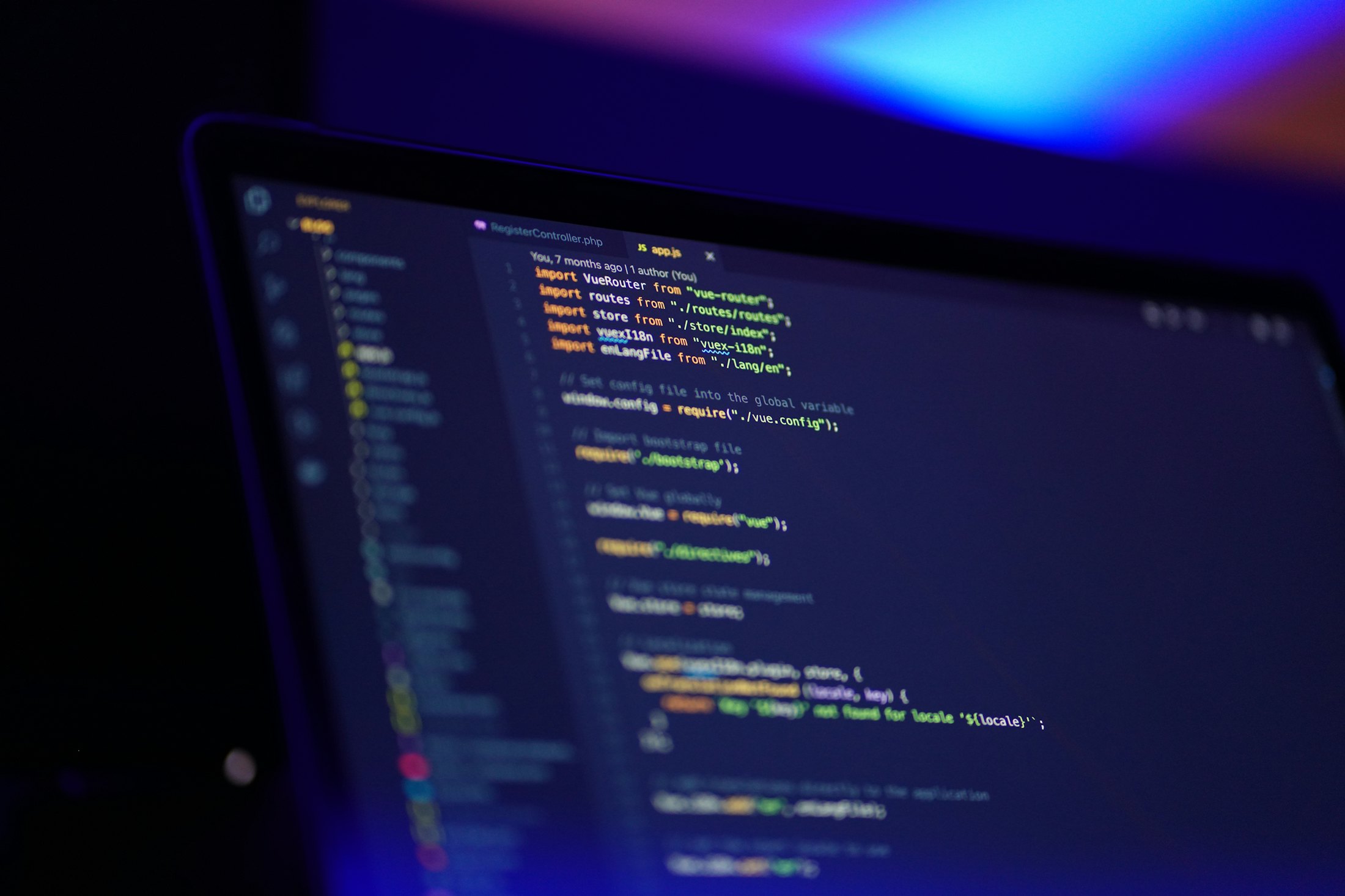 Source code on a laptop screen in a dark room